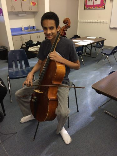 teen boy playing cello